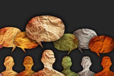 A photo of multi colored silhouettes with thought bubbles above their heads.